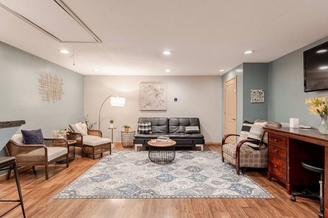 Unwind in the calm blue sitting room of Executive Apartment A, your quiet town base a short drive from our fluffy cow farm near the Smoky Mountains.