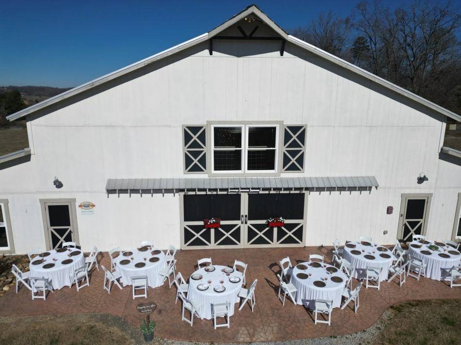 The Grand White Barn at Cedar Pond Farms, column-free and lit for an event