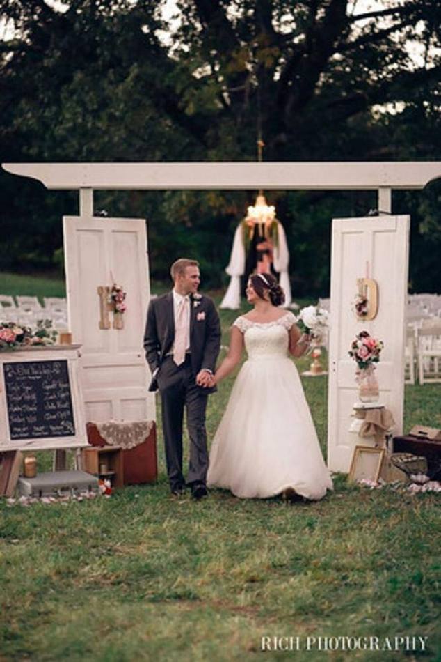 The Wooded White Arbor with its mounted wooden doors beneath the trees